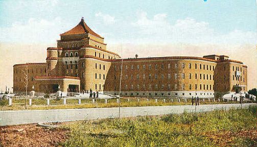 伪满综合法衙旧址全景:紫红色塔楼、弧线外墙、咖啡色贴面