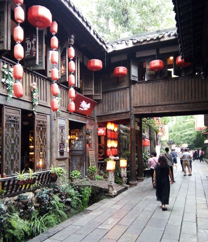 A traditional old building with intricate woodwork and red l