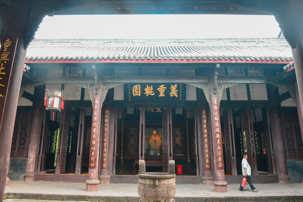 A traditional Chinese building with ornate wooden pillars an