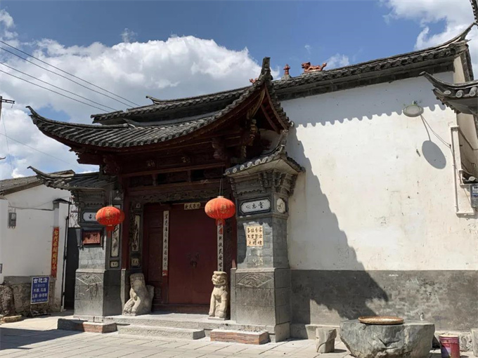 九坛神本主庙正门：白墙、红门、石狮与朴素的外观