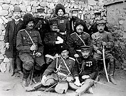 A group of soldiers and a woman, possibly Noguchi Kiyotaka and Stessel, are pose
