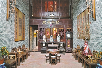 A traditional interior of a wealthy merchant's residence in Guangzhou's Xiguan, featuring elaborate wooden furniture, de