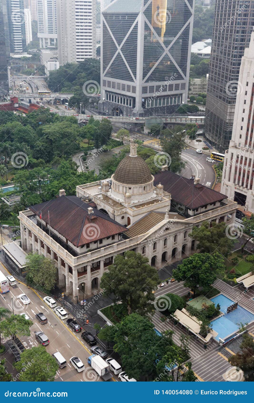 礼宾府鸟瞰，中央日式塔楼与浅粉色新古典主义主体的叠合清晰可见，周边诺福克松树划定府邸边界。