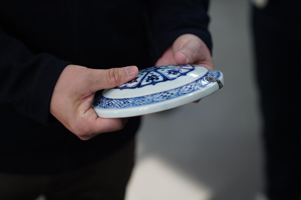 御窑博物院院长翁彦俊在修复实验室中展示一件刚完成修复的古陶瓷