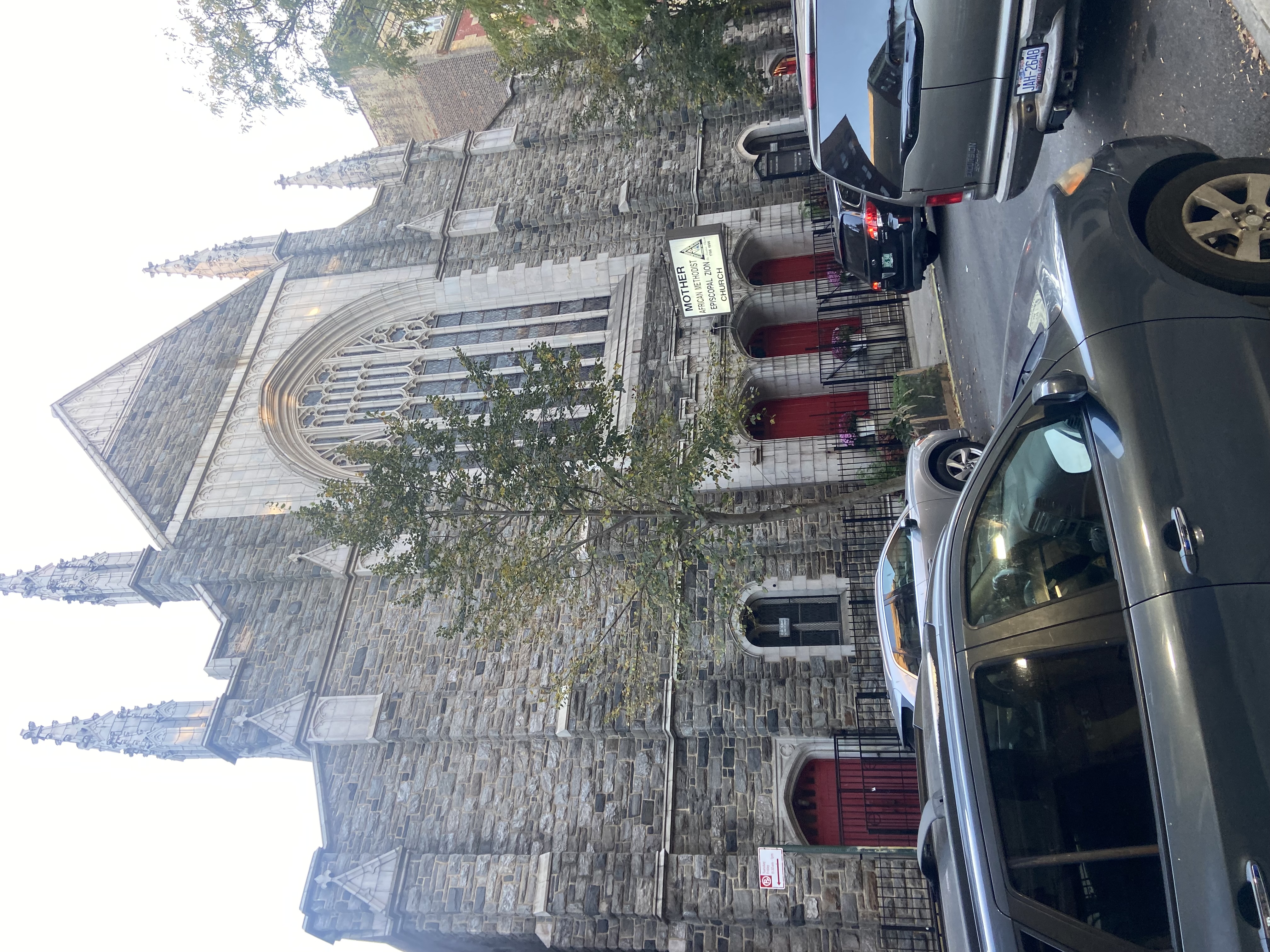 Mother AME Zion Church 侧前方视角，显示全立面、尖塔和 street-level 入口