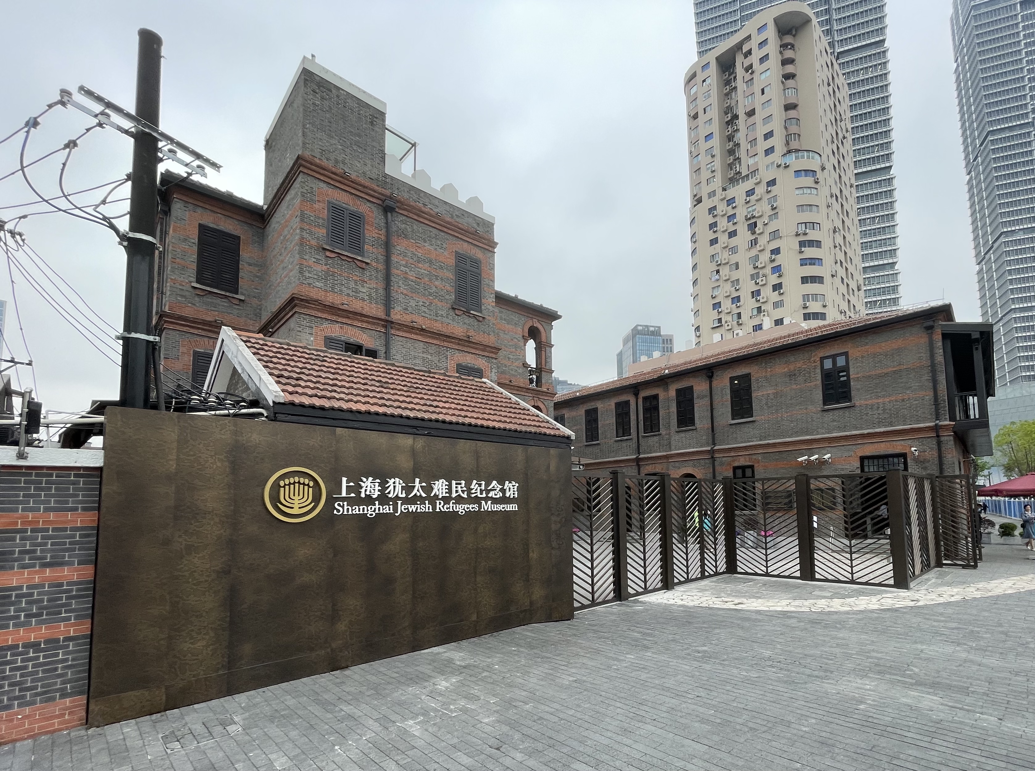 摩西会堂外景，青砖红瓦的三层外廊式建筑，门口嵌有六角星标志