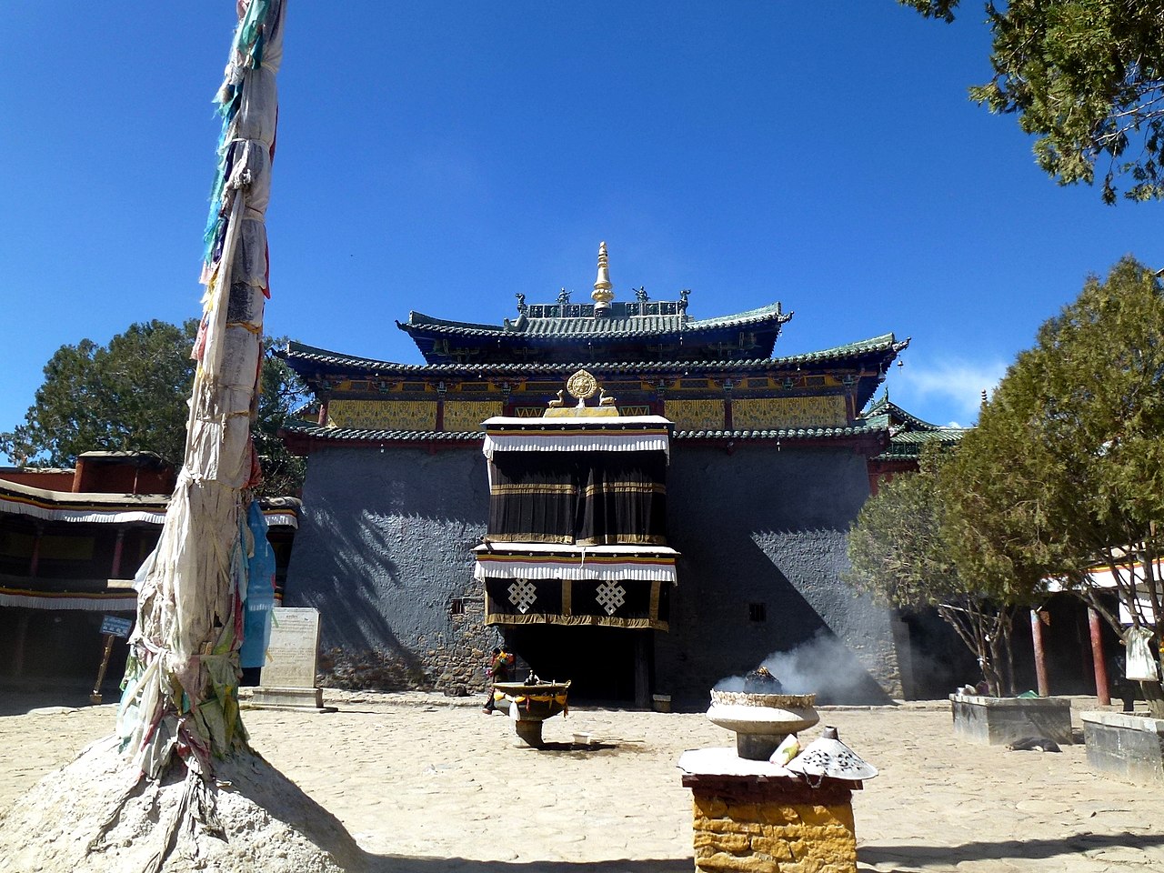 夏鲁寺主殿外观，底层藏式石砌碉房与上层汉式歇山琉璃瓦顶的垂直叠加