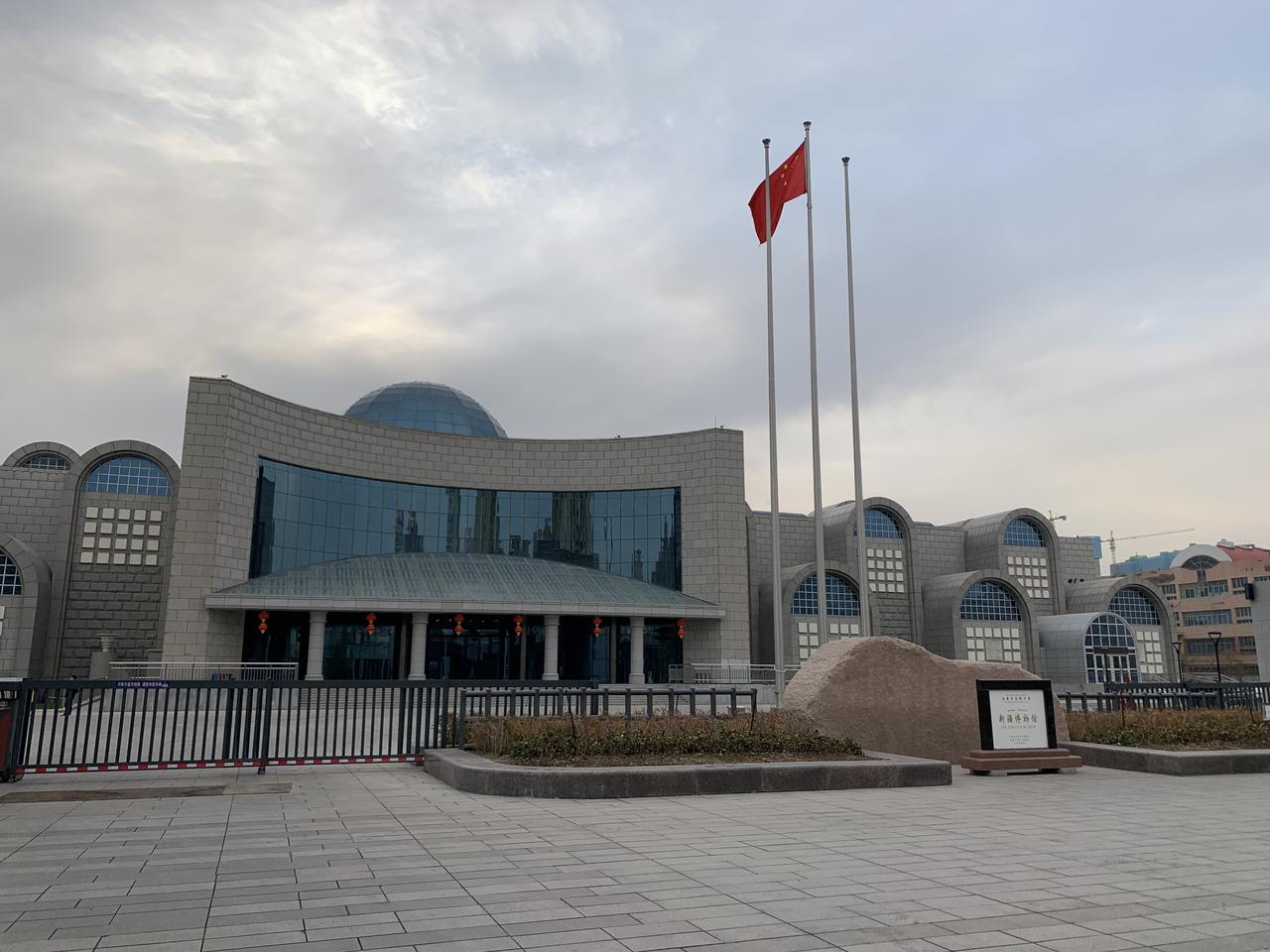 新疆博物馆外景,现代风格的弧形建筑和蓝色玻璃幕墙