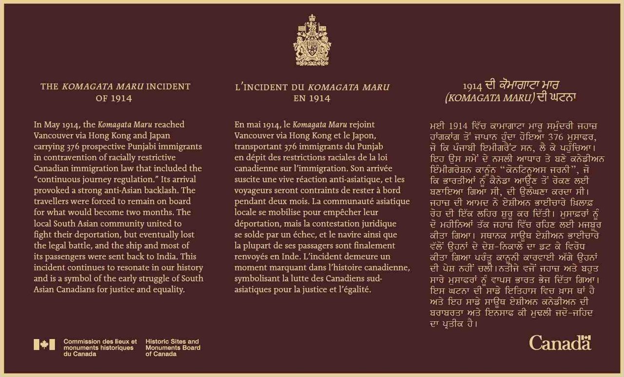 Parks Canada 三语国家历史事件 plaque，深色纪念牌上三种语言并列