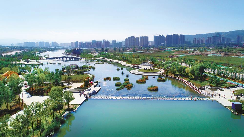 宁湖湿地公园的水道蜿蜒穿过芦苇荡，人工湿地不仅净化水质，也为候鸟提供了栖息地。
