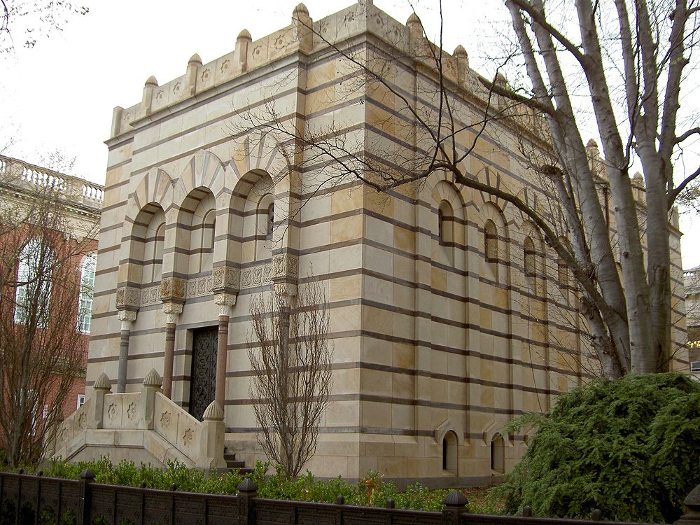 The striped Moorish Revival facade of Scroll and Key Society Hall at 484 College Street, showing the alternating light and dark stone bands and arched entrance