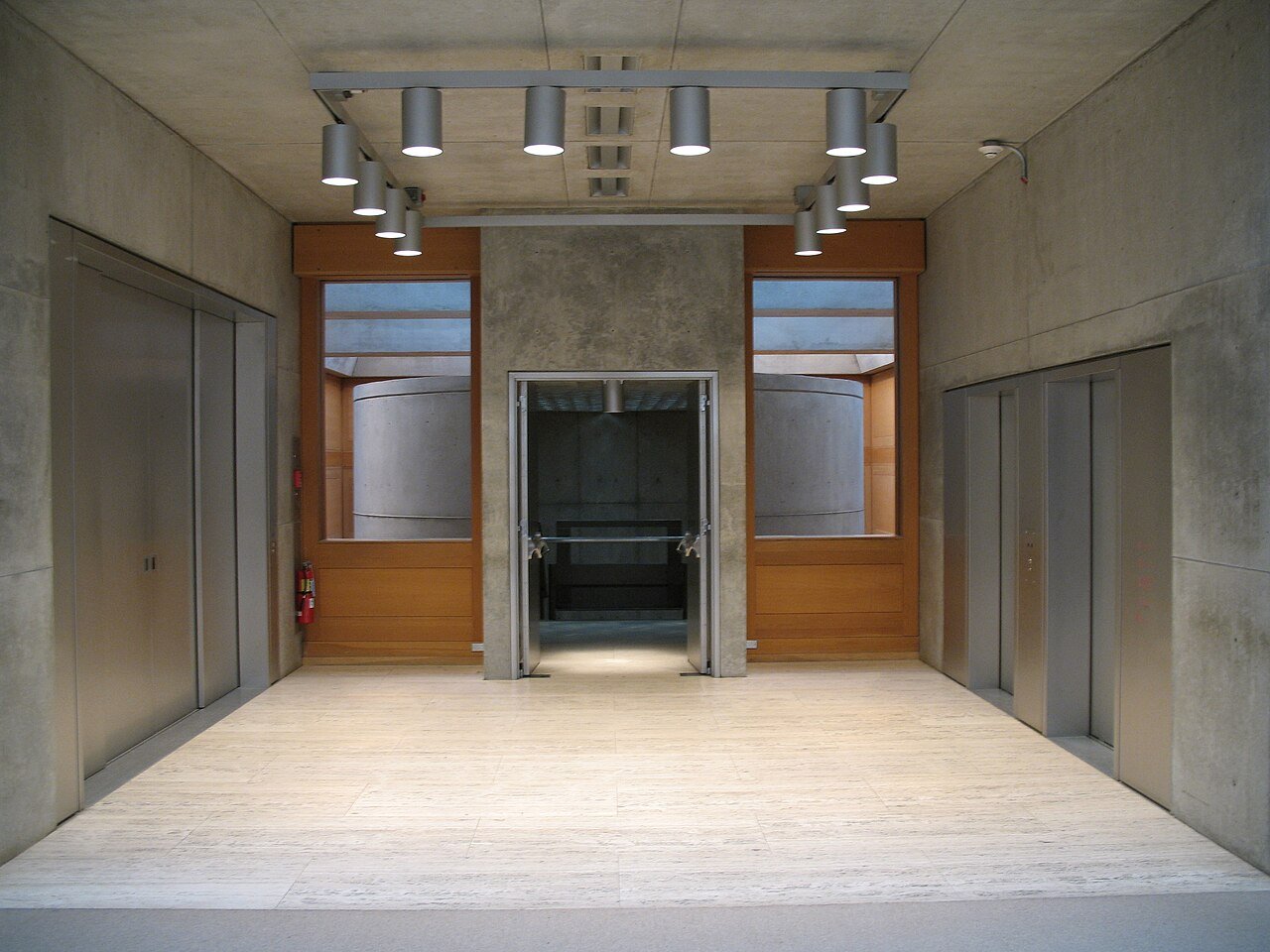 YCBA interior courtyard with travertine floor, white oak panels, and skylight