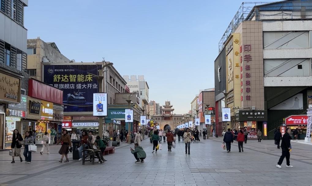 A bustling street in the old part of Yinchuan's Xingqing District, with people w