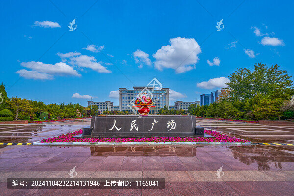 A spacious plaza features a large stone monument with Chinese characters, surrou