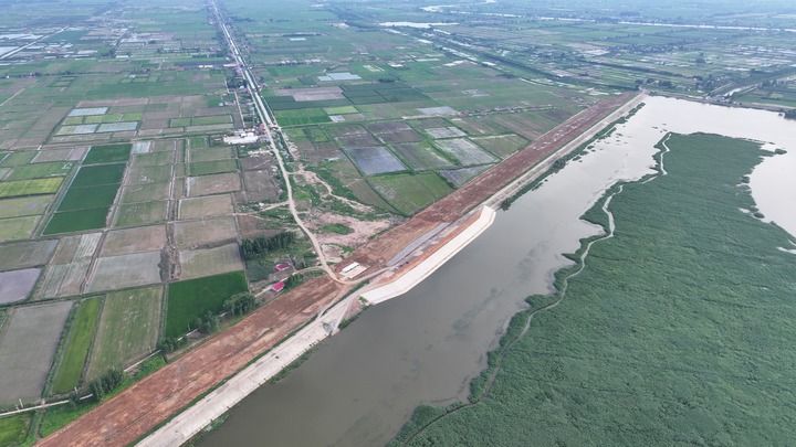修复加固后的团洲垸大堤，迎水面覆盖六边形水泥块衬砌，堤面比旧堤宽约一倍