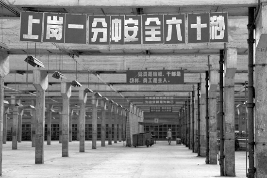 1950年代国棉厂工人操作纺织机的历史照片